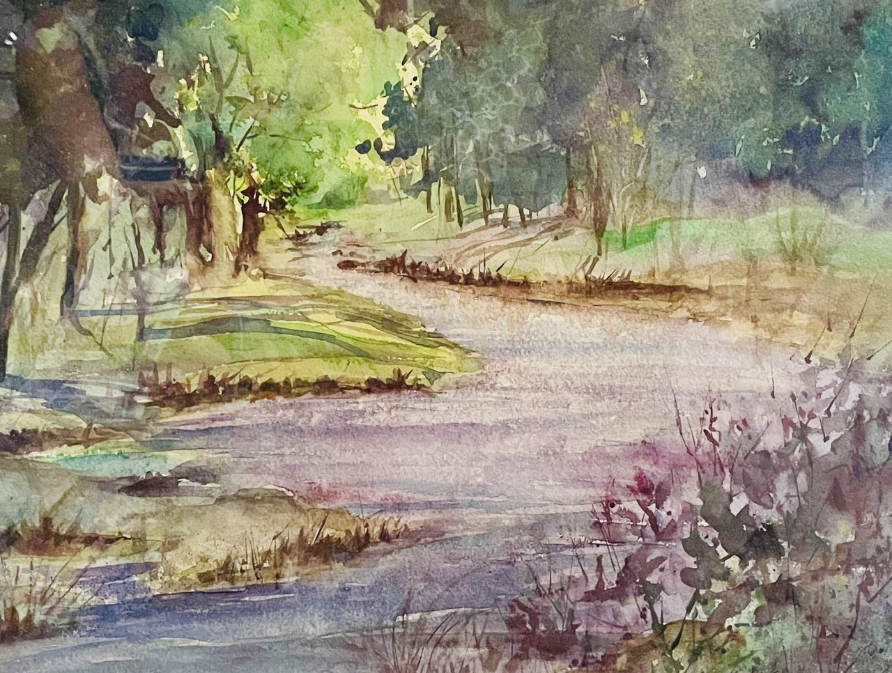 Watercolor of a sun-dappled woodland path by Vicki Stevens
