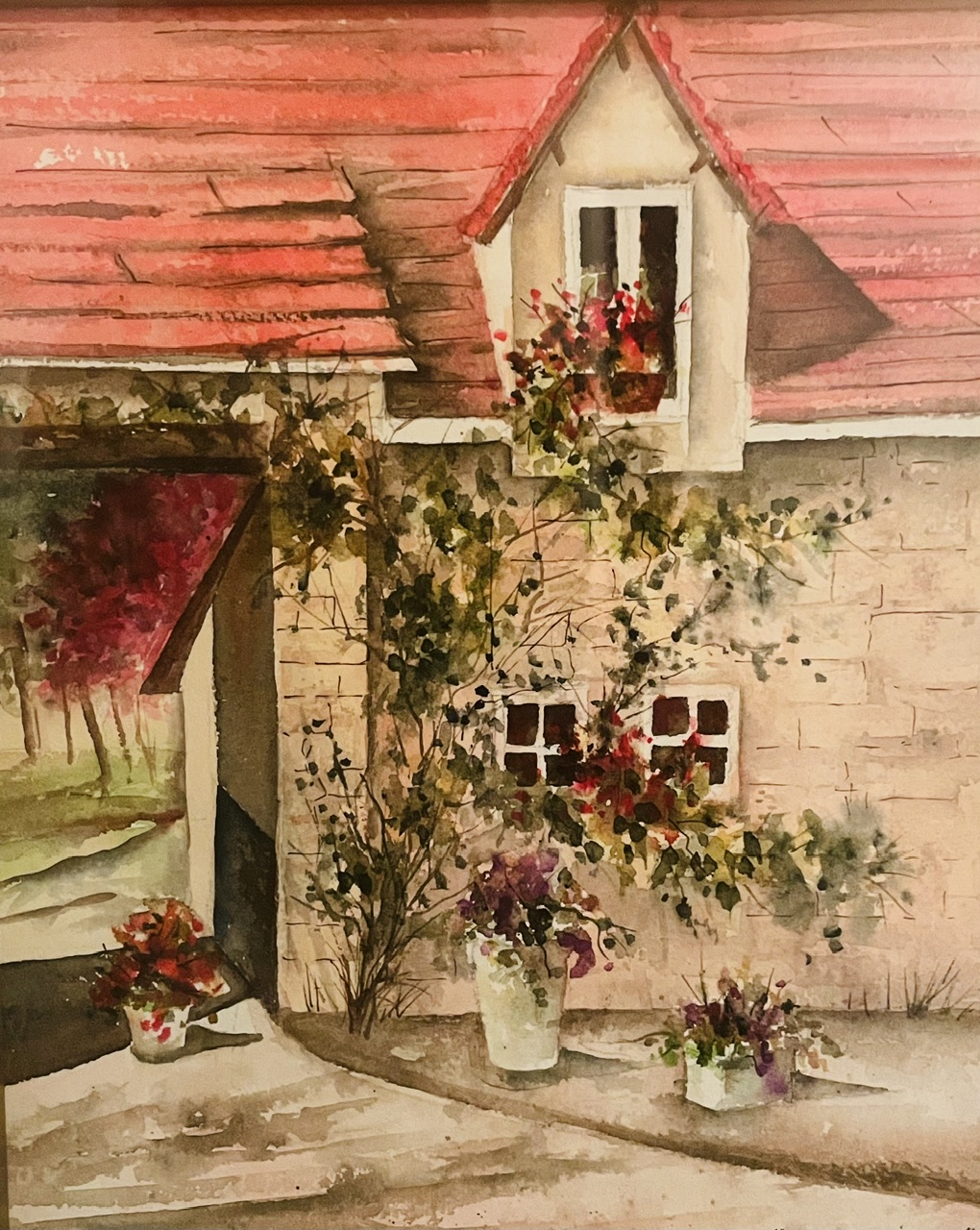 Watercolor of a stone cottage with red roof, climbing roses, and flower pots by Vicki Stevens